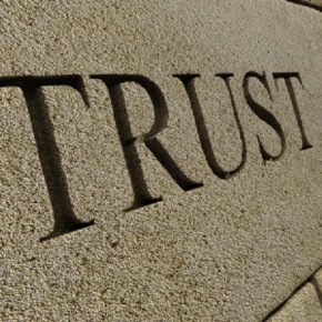 The word TRUST carved into a stone wall. 3D render with HDRI lighting and raytraced textures.